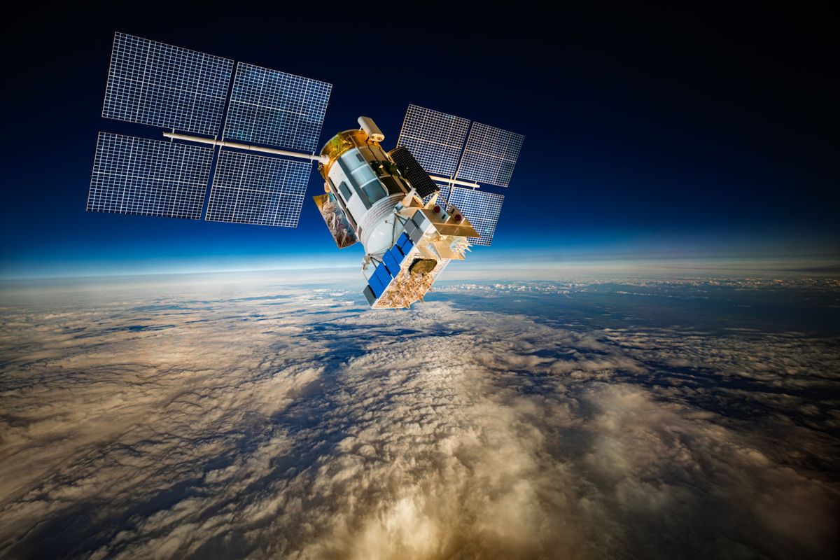 Detailed view of a satellite in space, featuring metallic structure, antennas, and large solar panels, orbiting above Earth's blue atmosphere and orange-tinted cloud layers against the dark void.