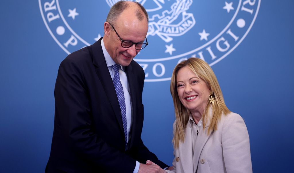 German Chancellor Merz and Italian Prime Minister Meloni shake hands and laugh