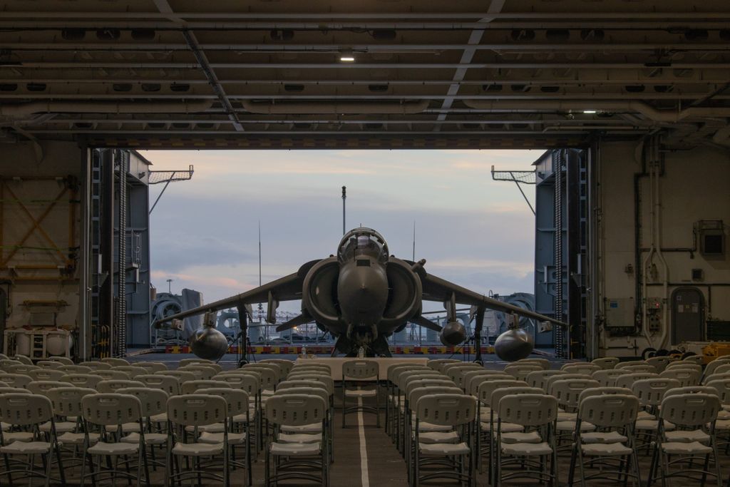 Barcelona, Spain; Oct 12 24: Vertical takeoff and landing plane Harrier AV-8B at the hangar of multi-purpose aircraft carrier-landing helicopter dock L-61 Juan Carlos I, arranged as a conference room.